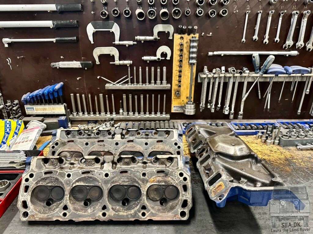 A pair of 1960's Ford Mustang 289 cui cylinder heads on a workbench